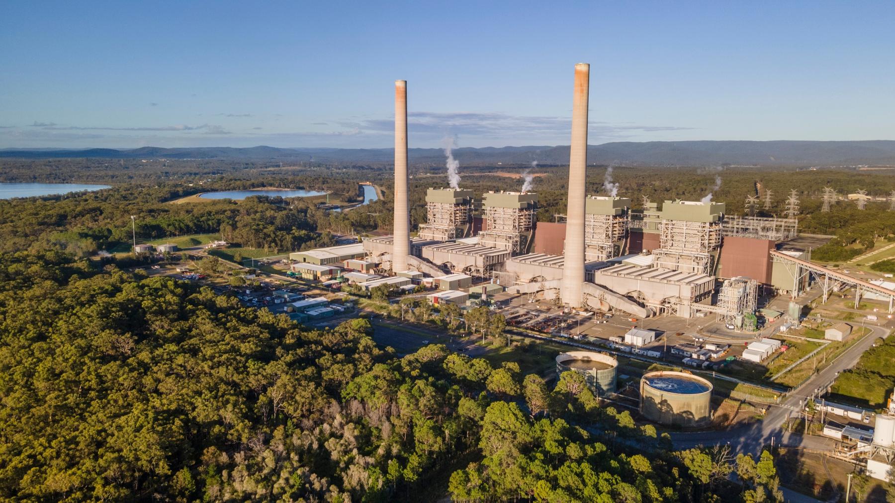 Arial shot of power station  - two coal stacks surrounded by bushland