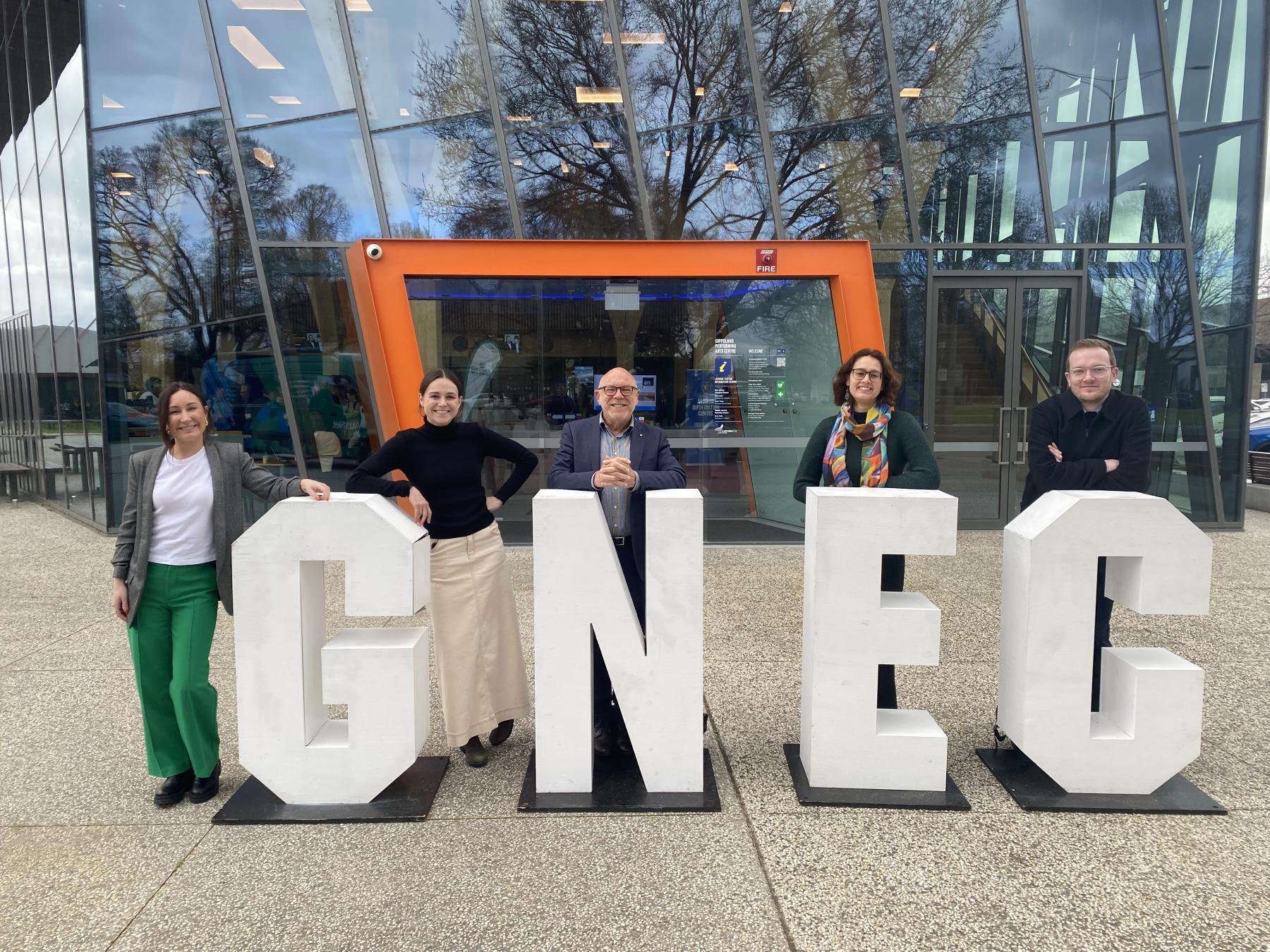 Five NZEA staff with display letters spelling 'GNEC'