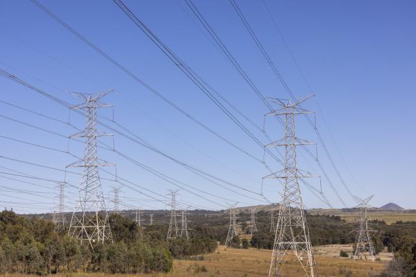Two towers supporting powerlines in an open landscape