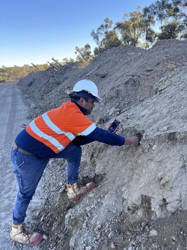 Tunuba Ranger checking bird nests within dirt mounds at Boulder Creek Wind Farm